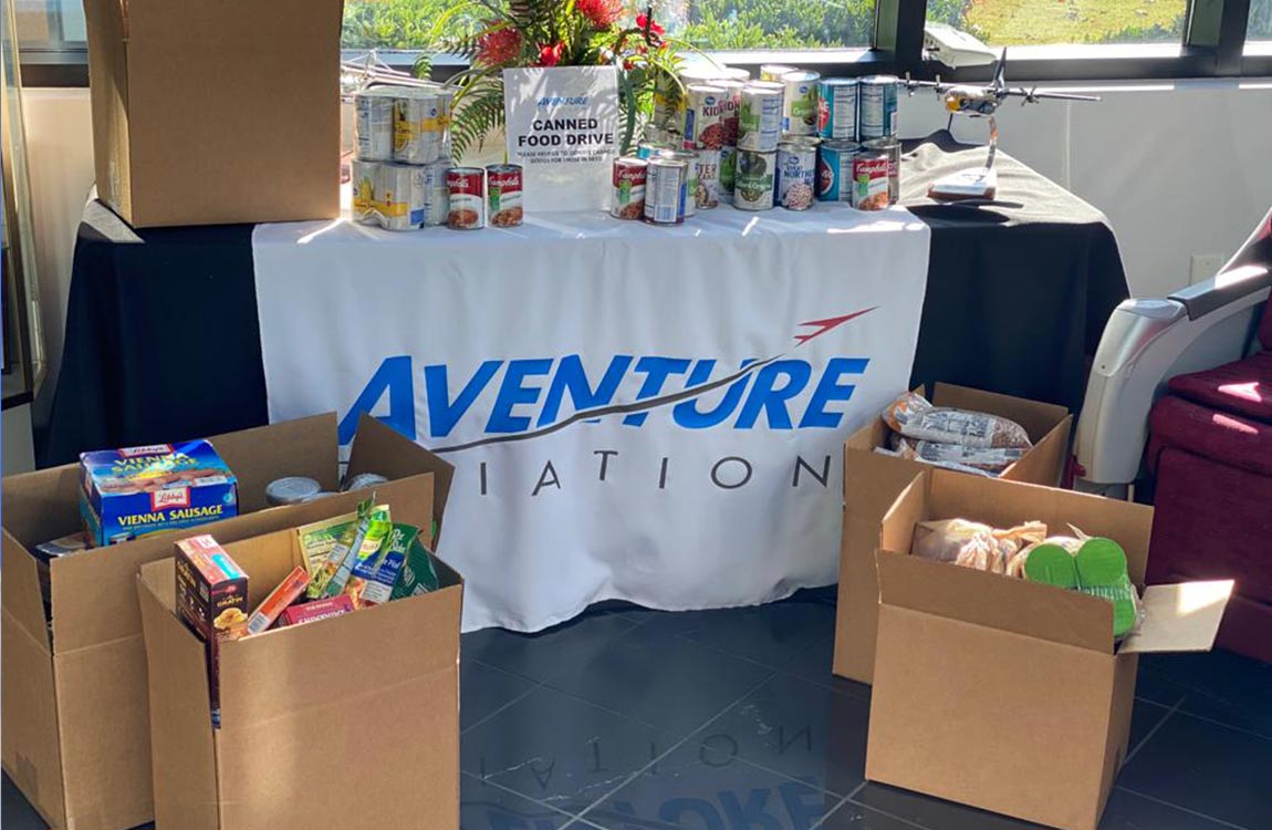 Boxes of canned food and other donations fill the lobby of Aventure Aviation's Atlanta headquarters
