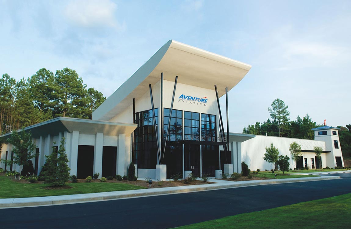 Aventure Aviation global headquarters building and warehouse, below a blue sky 