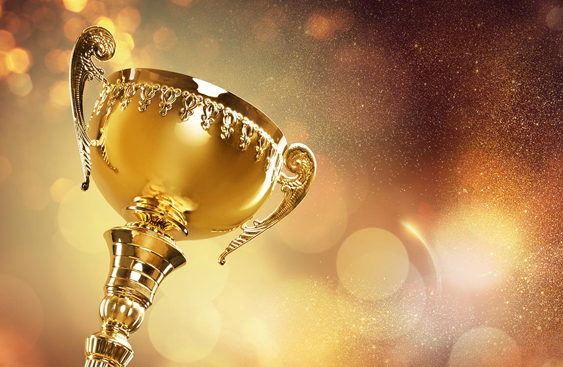 Golden trophy in front of a celebratory glitter background 
