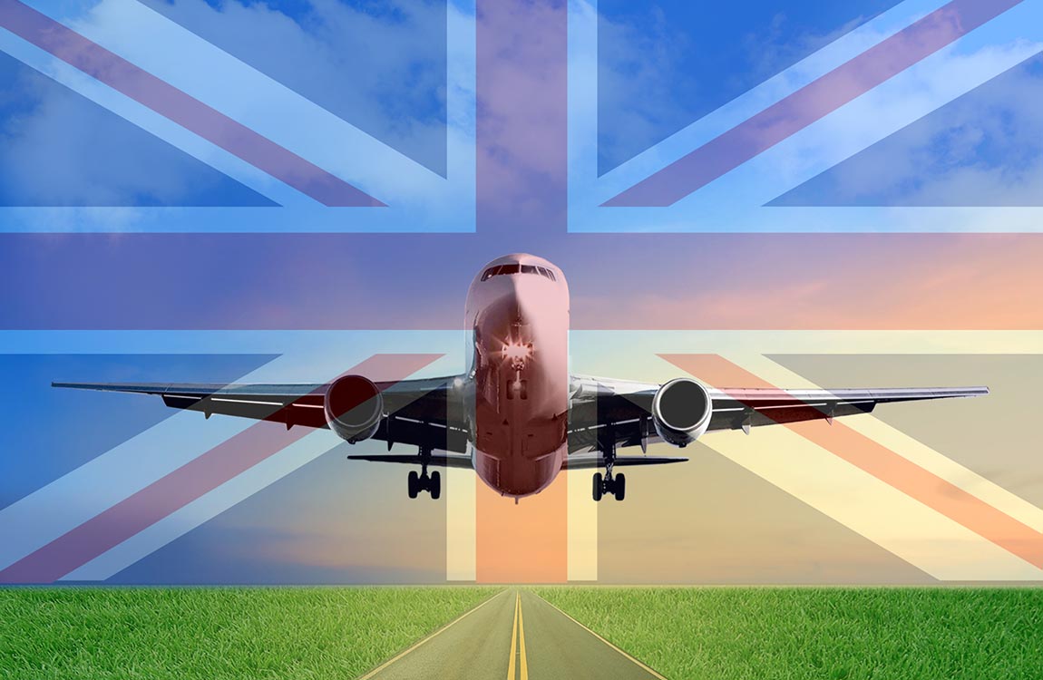 Photo composite of a commercial airplane taking off under a British Flag superimposed over the sky 