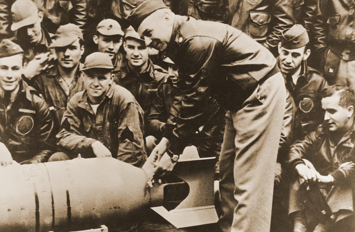 WW2 era photo of military men on the deck of an aircraft carrier 