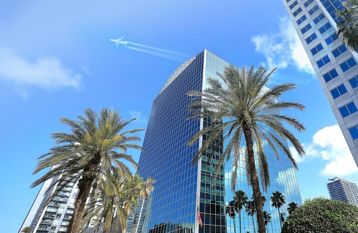 A commercial airliner flies over the Orlando skyline 