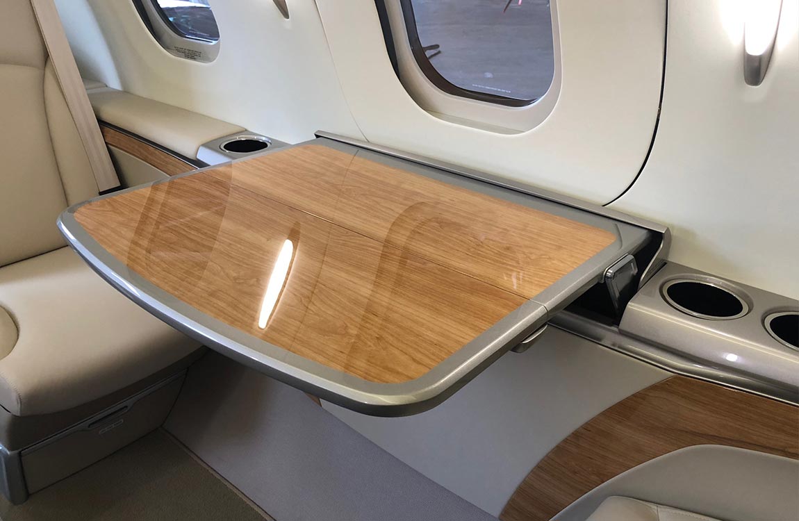 A beautiful, glossy wood print table on a private plane 